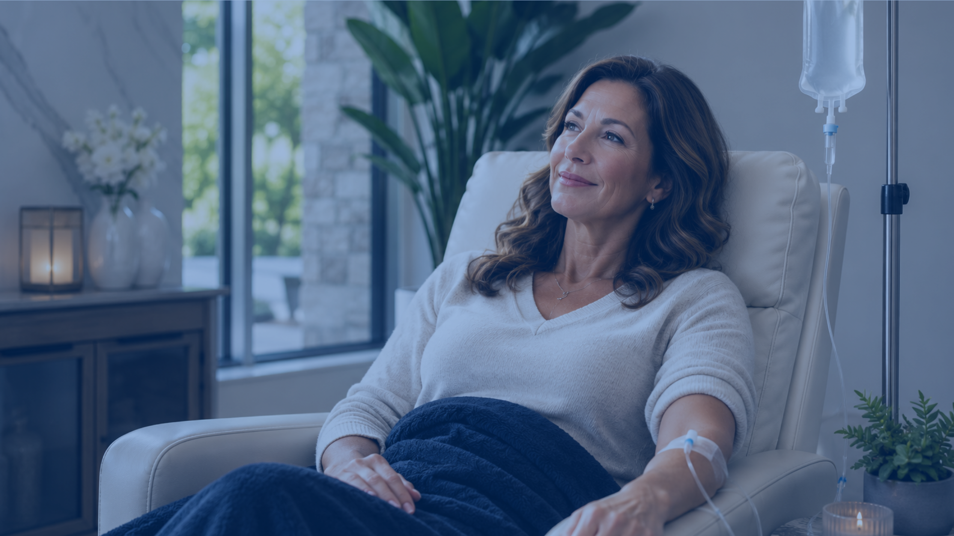 A woman relaxing in a comfortable recliner during an IV therapy session at a wellness spa